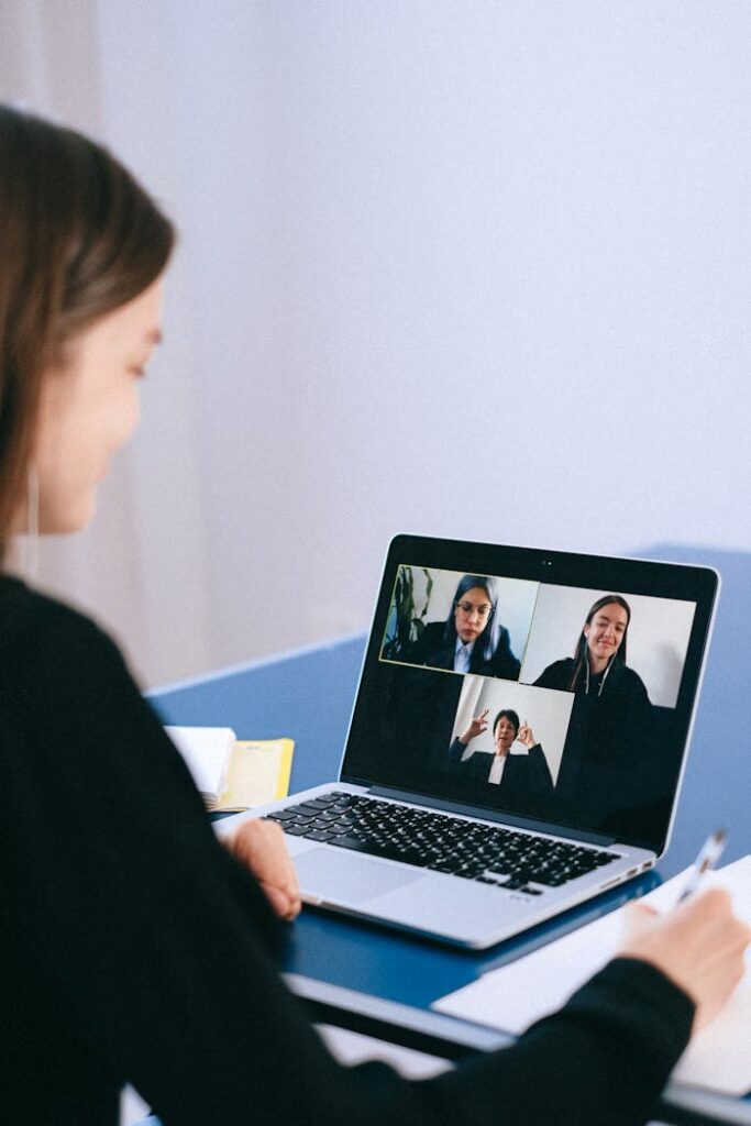 pexels-photo-4226122 A woman participates in a virtual meeting with colleagues via video call on a laptop.